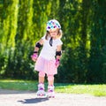 Little girl with roller skate shoes in a park Royalty Free Stock Photo